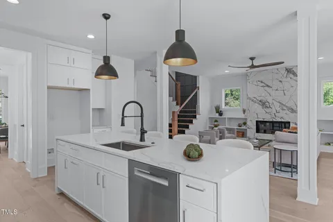 a kitchen with stainless steel appliances a stove a sink a refrigerator and a wooden cabinets