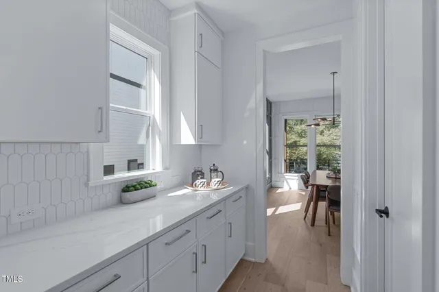 an empty room with wooden floor and a window