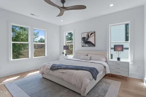 a bedroom with a large bed and a window