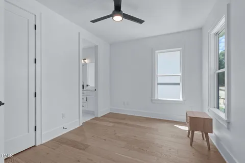 an empty room with windows and closet