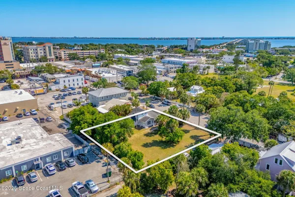 an aerial view of a residential houses with outdoor space