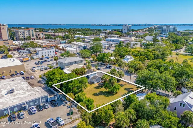 an aerial view of a residential houses with outdoor space