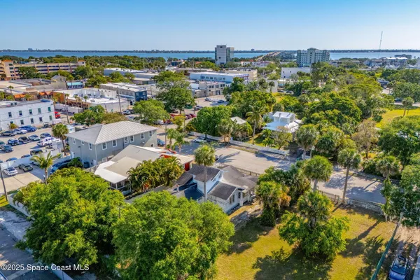 an aerial view of a house with a yard