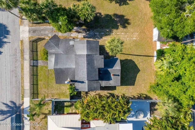 a view of a big yard with large trees