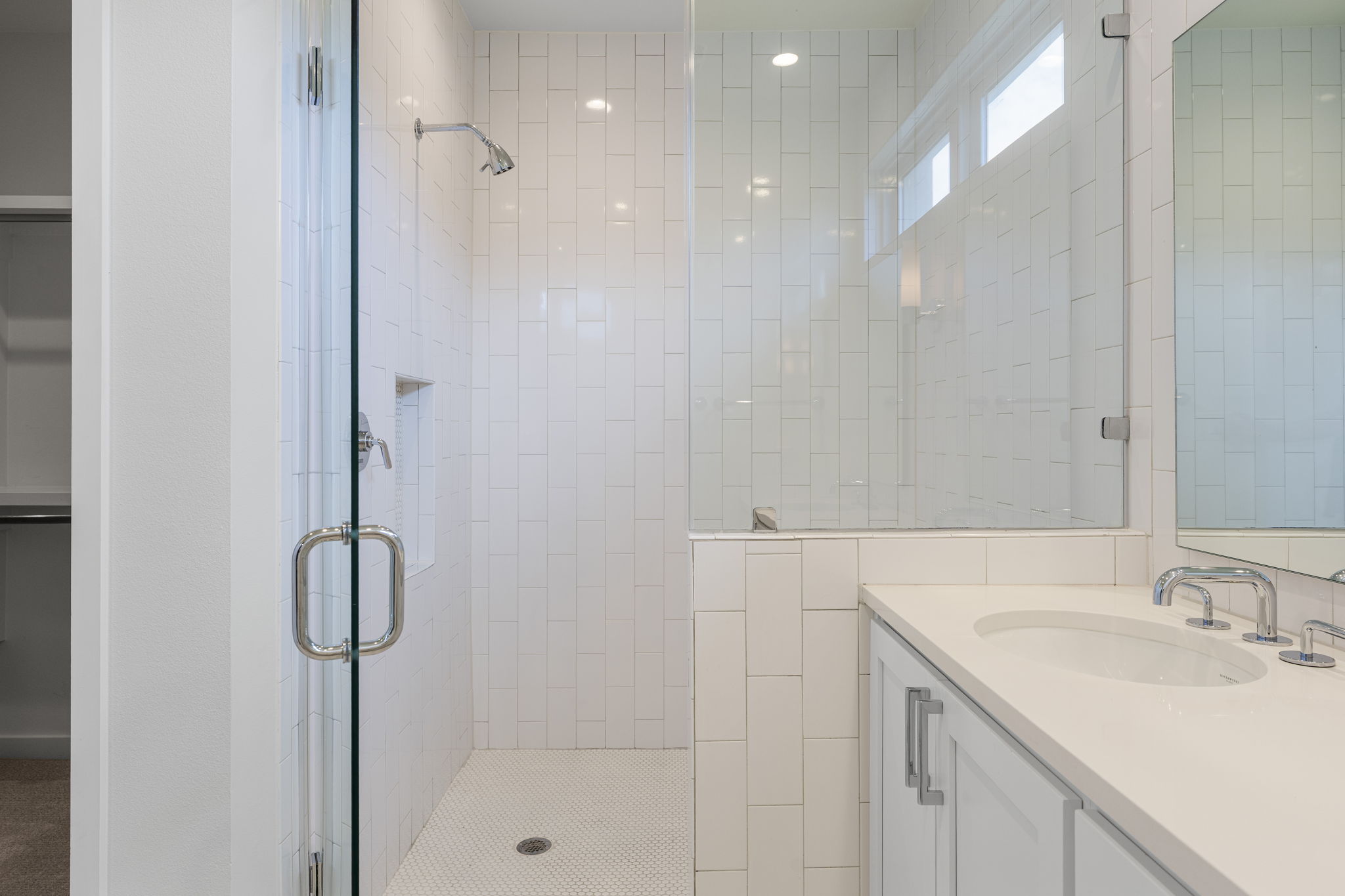 2520 Sutherland Street Austin, TX 78746 - Photo 18 of 26 A well-appointed bath features a spacious walk in shower a bench and niche with vertical wall tile and gorgeous vanity with Waterworks luxury.
