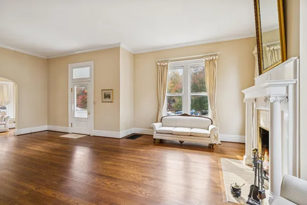 a view of empty room with wooden floor and window