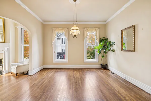 a view of empty room with wooden floor and fireplace