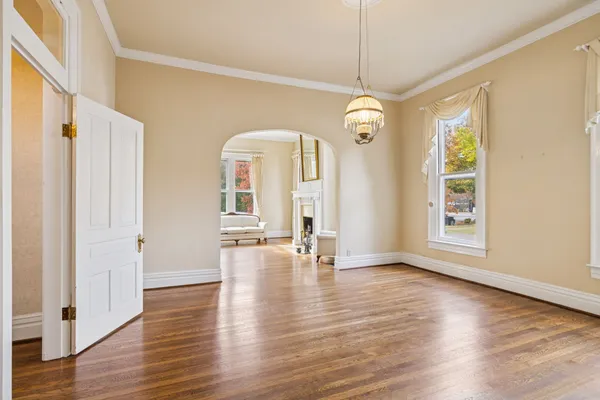 a view of a livingroom with wooden floor and a ceiling fan