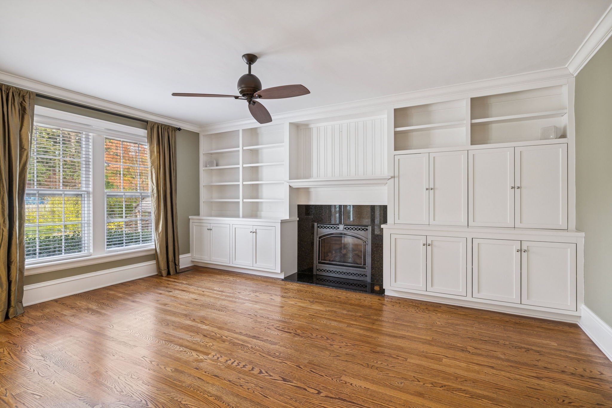215 4th Avenue South Franklin, TN 37064 - Photo 64 of 86 a view of a livingroom with wooden floor a ceiling fan and windows