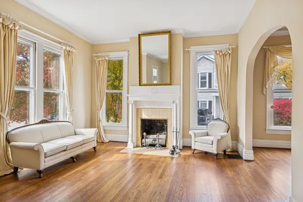 a view of a room with wooden floor and a window