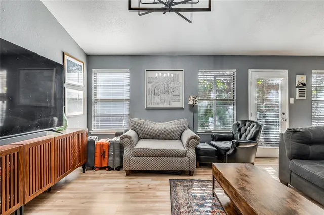 a living room with furniture and a floor to ceiling window