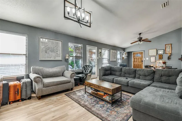 a living room with furniture ceiling fan and a window
