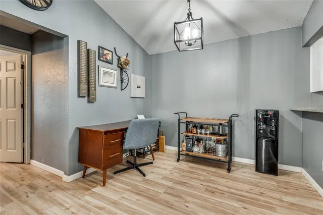 a view of a workspace with furniture and wooden floor
