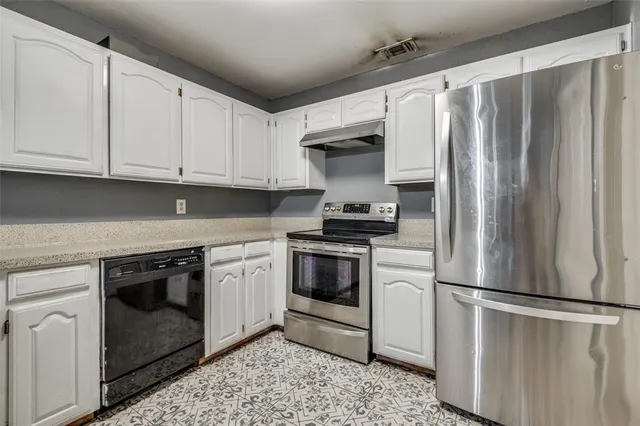 a kitchen with stainless steel appliances a refrigerator sink and cabinets