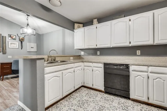 a kitchen with granite countertop white cabinets and white appliances