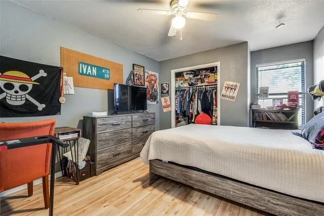 a bed room with a bed and a flat tv screen