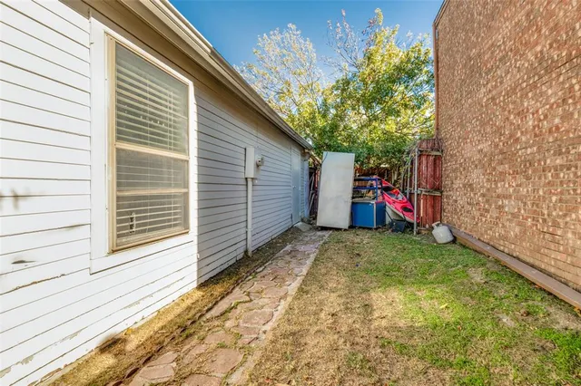 a view of a backyard with a small cabin and a chair