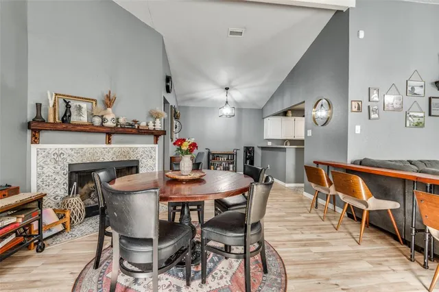 a view of a dining room with furniture and a fireplace