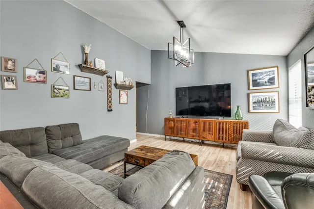 a living room with furniture kitchen view and a window