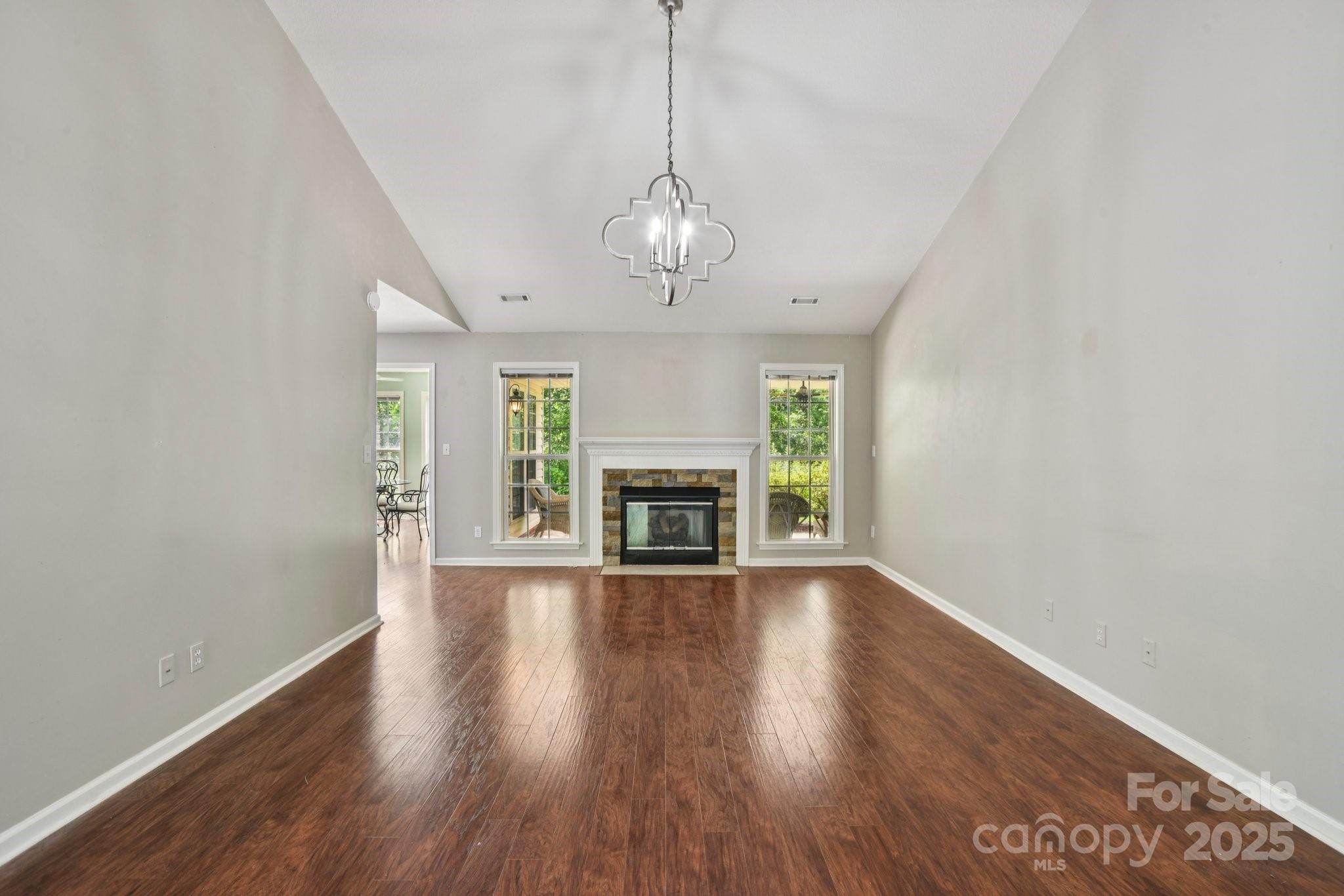 343 Stonehollow Road Fletcher, NC 28732 - Photo 11 of 36 a view of an empty room with wooden floor fireplace and a window
