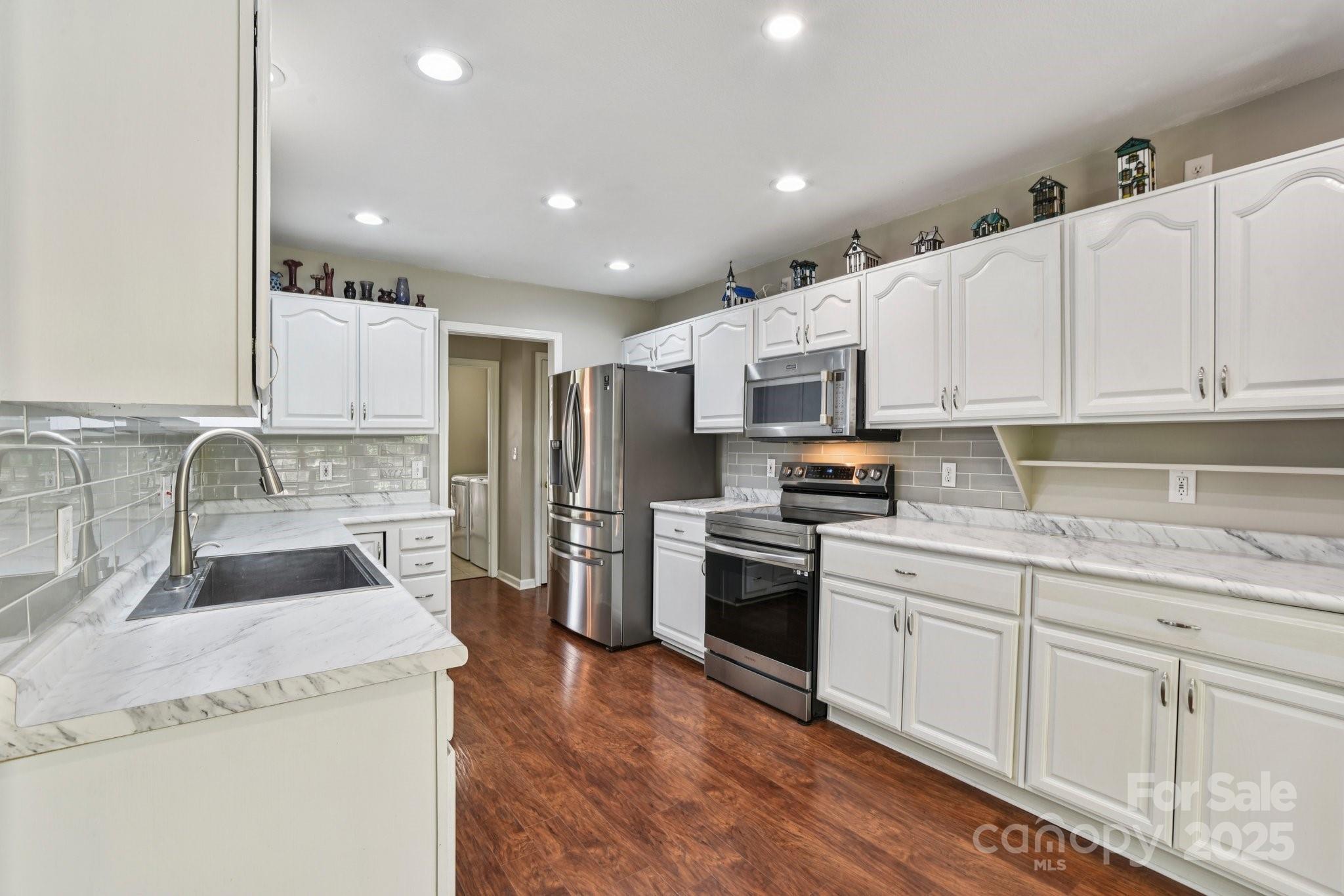 343 Stonehollow Road Fletcher, NC 28732 - Photo 13 of 36 a kitchen with granite countertop a sink stainless steel appliances and cabinets