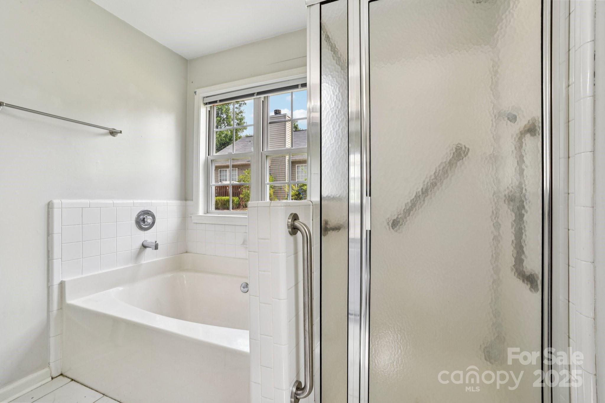 343 Stonehollow Road Fletcher, NC 28732 - Photo 18 of 36 a bathroom with a bathtub and a shower