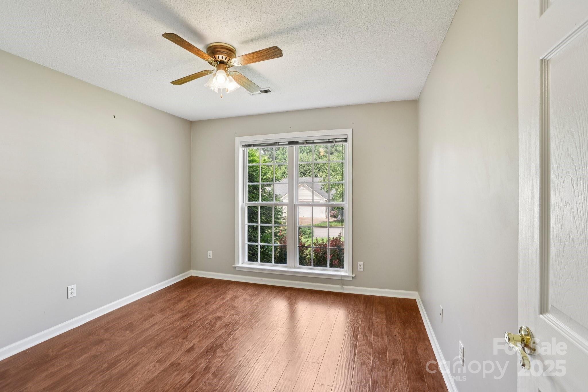 343 Stonehollow Road Fletcher, NC 28732 - Photo 21 of 36 an empty room with wooden floor and windows