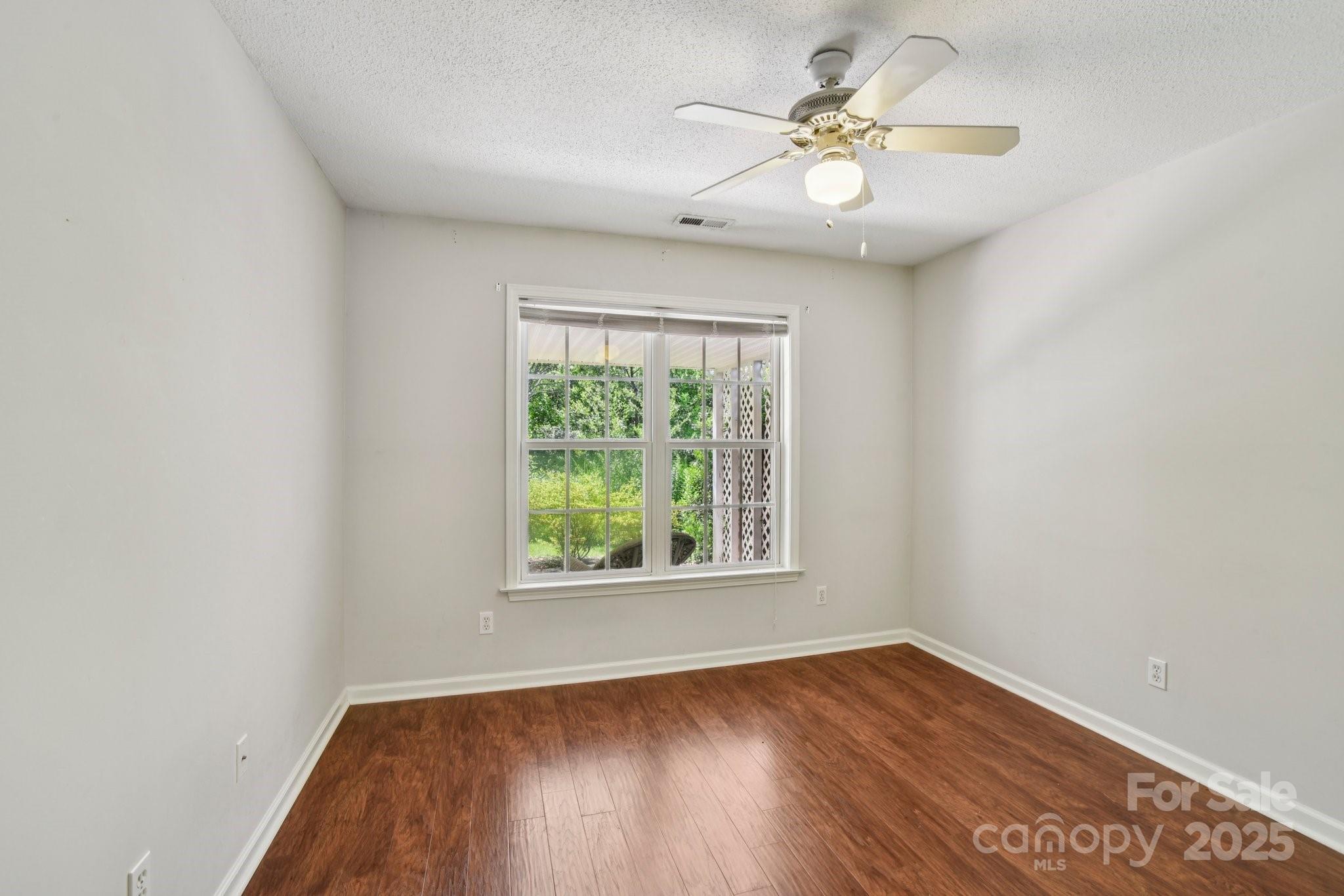 343 Stonehollow Road Fletcher, NC 28732 - Photo 22 of 36 an empty room with wooden floor and windows
