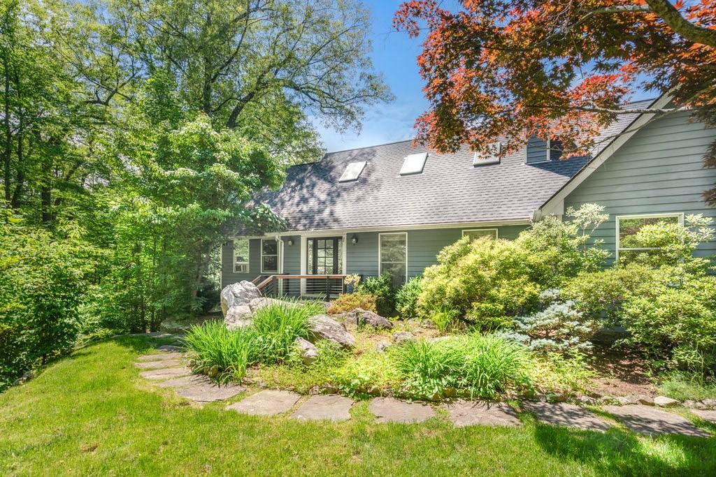 a front view of house with a garden