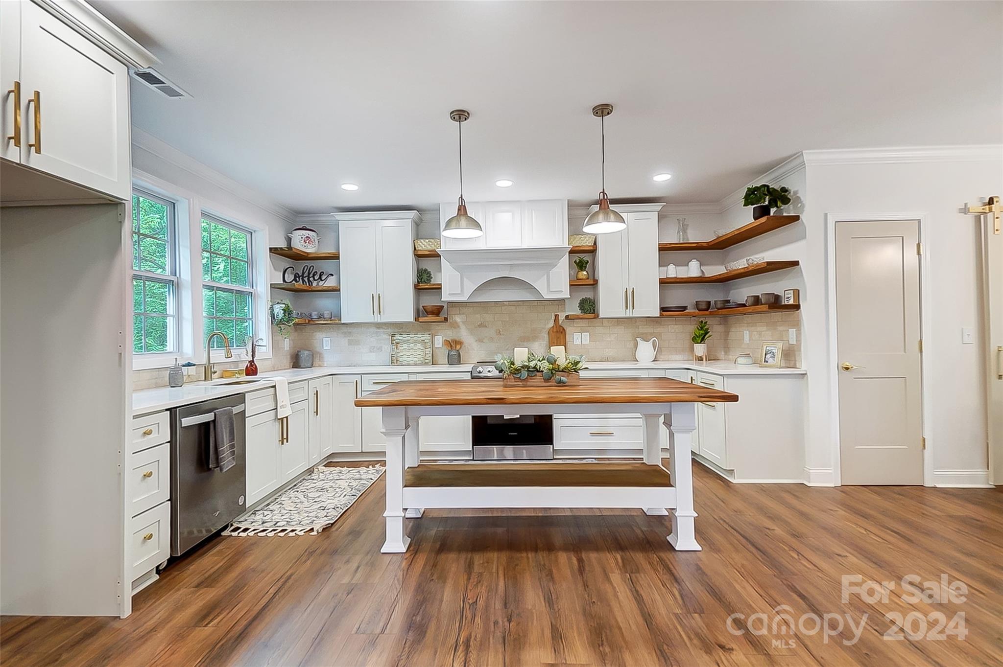 1129 Duckwood Road Lancaster, SC 29720 - Photo 16 of 48 a kitchen with kitchen island granite countertop a sink cabinets and wooden floor
