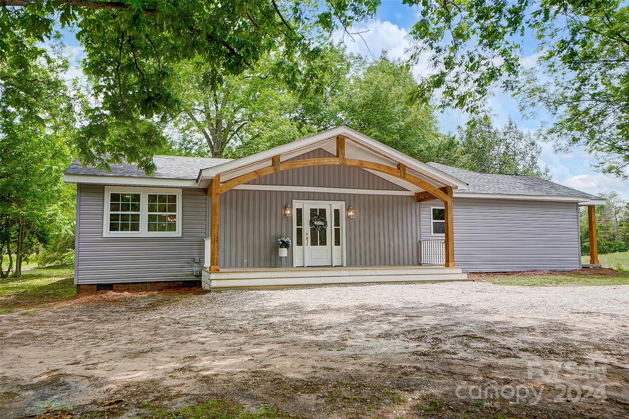 1129 Duckwood Road Lancaster, SC 29720 - Photo 2 of 48 a front view of a house with a garden
