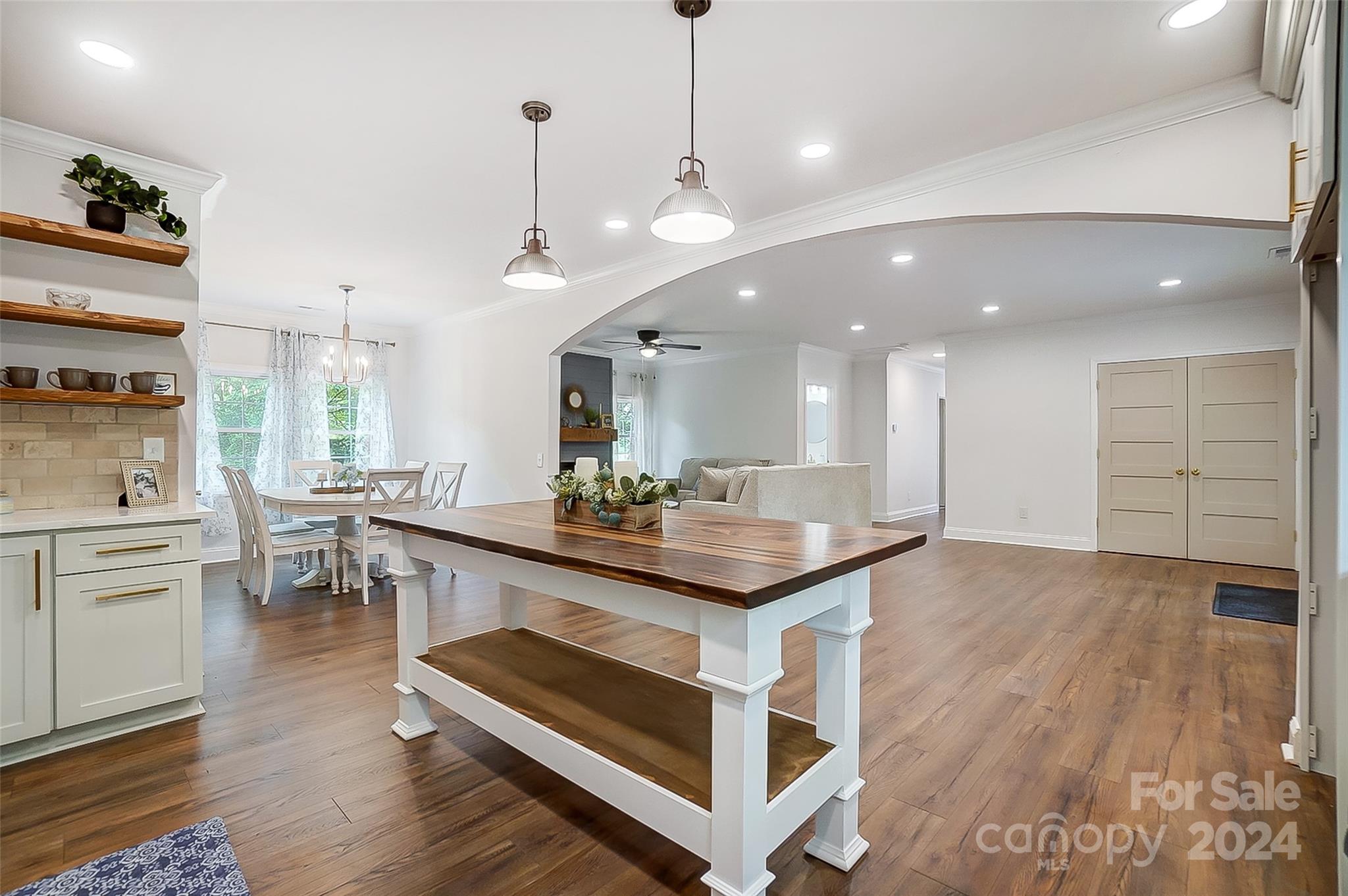 1129 Duckwood Road Lancaster, SC 29720 - Photo 23 of 48 a kitchen with stainless steel appliances granite countertop a stove a sink dishwasher and a dining table with wooden floor
