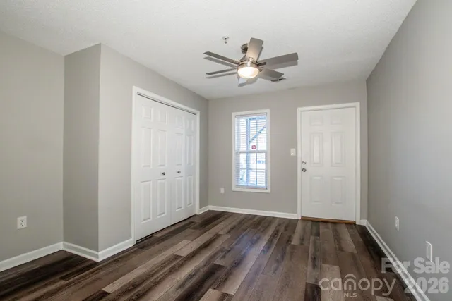 a view of a livingroom with a window and wooden floor