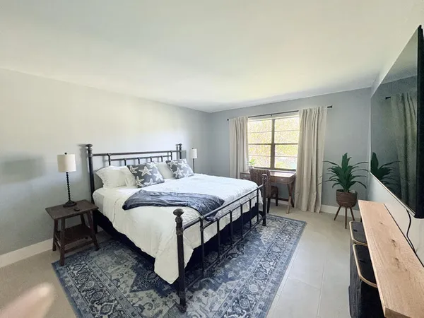 a bed sitting in a bedroom next to a window