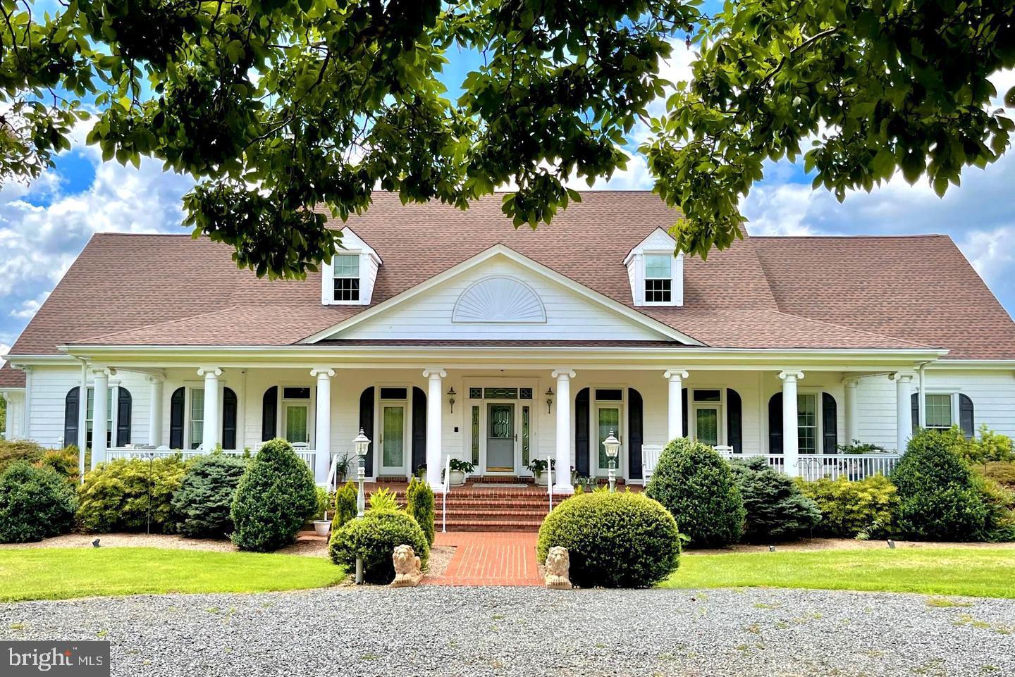 17235 Whisper Hill Road Culpeper, VA 22701 - Photo 1 of 24 a front view of a house with garden and plants