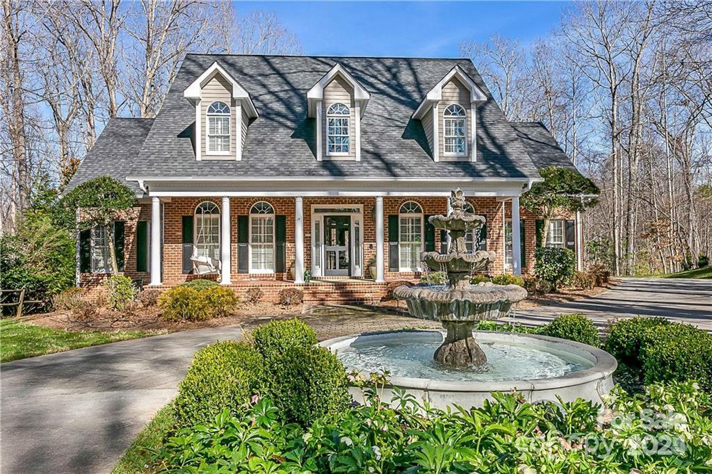8820 Alpine Circle Charlotte, NC 28270 - Photo 1 of 2 a front view of a house with garden and plants