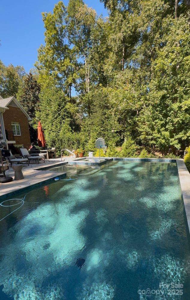 8820 Alpine Circle Charlotte, NC 28270 - Photo 2 of 2 a view of a swimming pool with an outdoor space and seating area