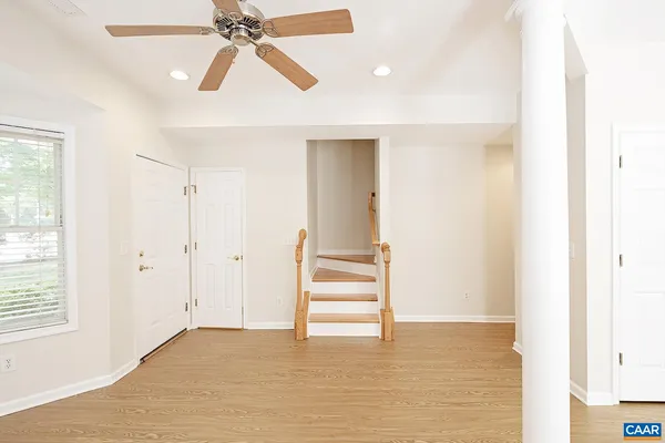 a view of empty room with wooden floor and window