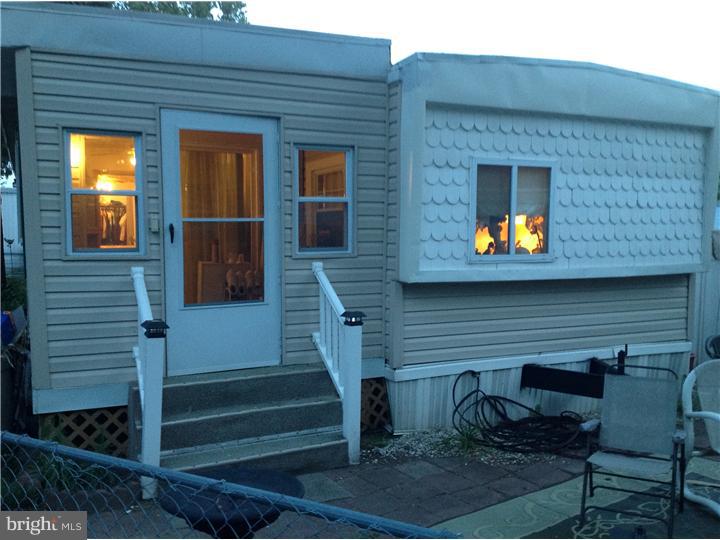1762 Crown Point Road, Unit E9 Thorofare, NJ 08086 - Photo 1 of 23 a view of house with wooden door and outdoor seating