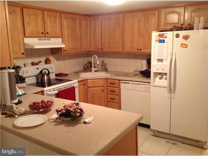 1762 Crown Point Road, Unit E9 Thorofare, NJ 08086 - Photo 14 of 23 a kitchen with a sink a stove and refrigerator