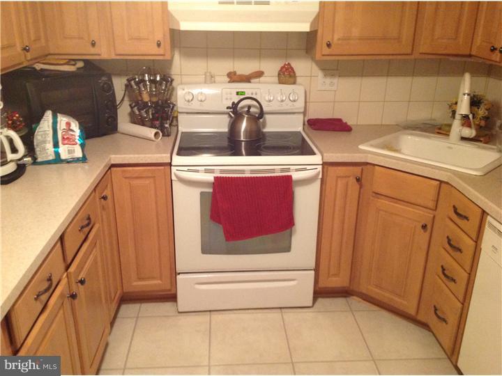 1762 Crown Point Road, Unit E9 Thorofare, NJ 08086 - Photo 17 of 23 a kitchen with stainless steel appliances granite countertop a sink and cabinets