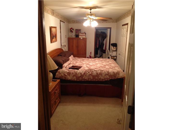 1762 Crown Point Road, Unit E9 Thorofare, NJ 08086 - Photo 21 of 23 a bed room with furniture and a chandelier