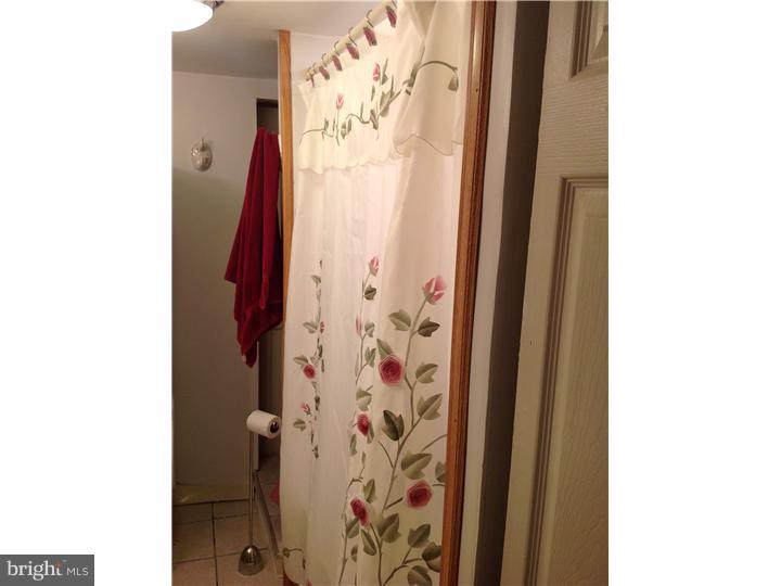 1762 Crown Point Road, Unit E9 Thorofare, NJ 08086 - Photo 23 of 23 a bathroom with a shower and a curtain