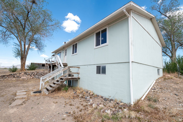 570 West Main Street Beaver, UT 84713 - Photo 3 of 43 Light blue siding exterior featuring multiple windows and a white trim