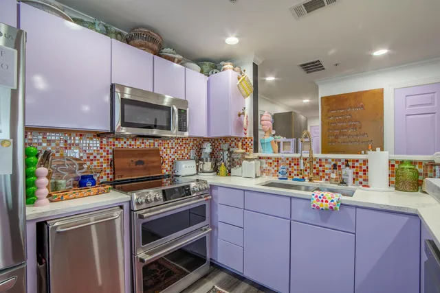 a kitchen with stainless steel appliances a refrigerator sink and microwave
