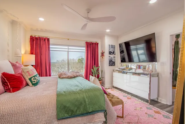 a bedroom with furniture and a large window