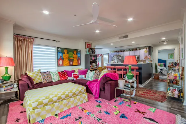 a bedroom with three beds and a chandelier