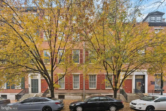 a front view of a building with trees