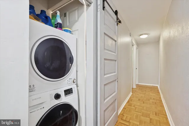 a view of a hallway with washer and dryer