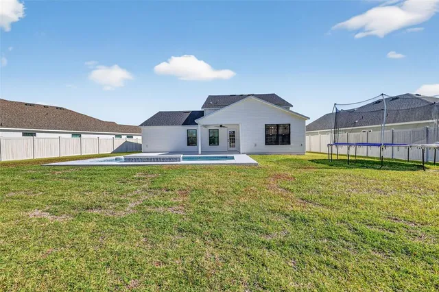 a front view of a house with a big yard